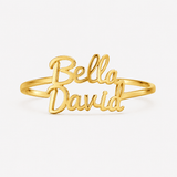 A gold-plated name ring featuring the script names 'Bella' and 'David' on a clean white background.at at shine gold and diamonds